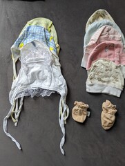 A delicate set of newborn hats and mittens to keep a baby warm and safe.

