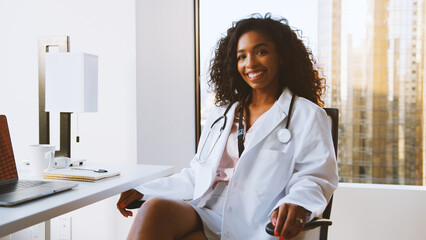Portrait Of Smiling Female Doctor Wearing White Coat With Stethoscope In Hospital Office