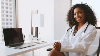 Portrait Of Smiling Female Doctor Wearing White Coat With Stethoscope In Hospital Office