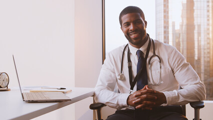 Portrait Of Smiling Male Doctor With Stethoscope In Hospital Office