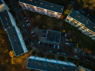 Aerial view of apartment buildings with blue trim casting long shadows in golden light, Suchanino neighborhood, Gdansk, Pomorskie, Poland.