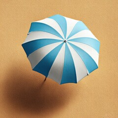 An overhead view captures a blue and white beach umbrella casting a shadow on textured sand.