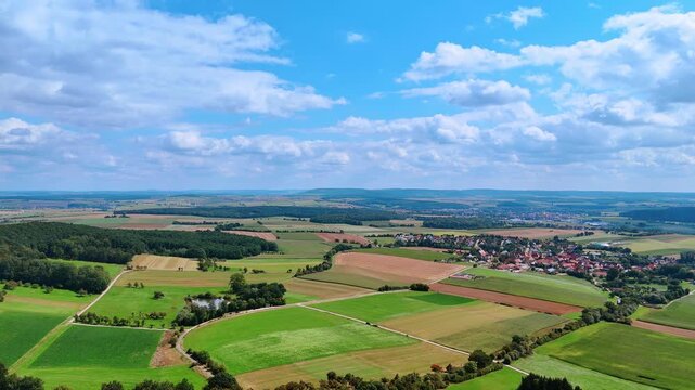 Rolling hills and farmland lines. Rolling green hills mix with farmland stripes under bright sky