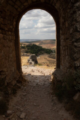 Obraz premium View of the scenic landscape from an ancient archway in Atienza, Guadalajara, Spain, showcasing natural beauty and historical architecture