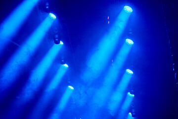 Industrial stage lighting mounted on aluminum frames inside the venue, prepared to illuminate the live performance area