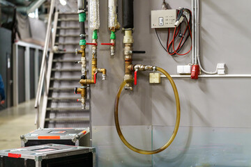 Pipes, valves, and faucets of the fire system in a venue ensuring safety and emergency readiness during concerts and events