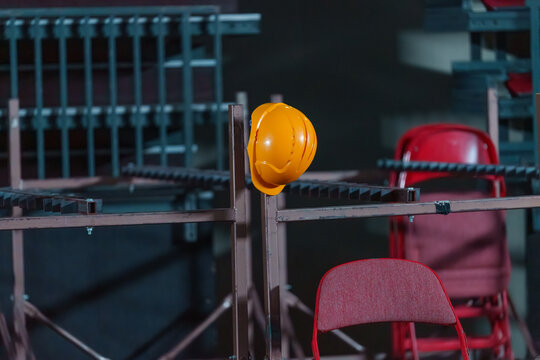 Stage crew safety helmets neatly arranged backstage, prepared for use during concert setup and rigging work