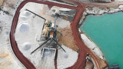 Aerial view showing sand quarry with dredging equipment producing quartz sand and processing aggregates