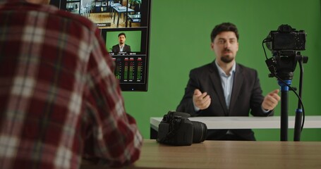 A modern live streaming studio featuring a presenter in front of a green screen with advanced equipment. A man in a suit presents information or news. Ideal for media production.