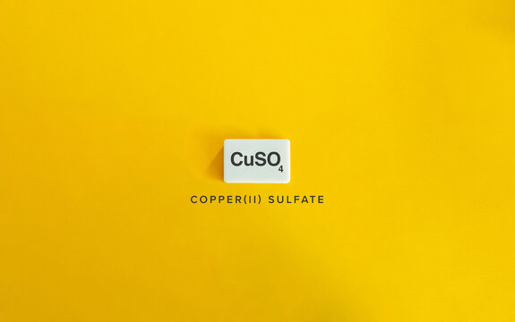 Copper(II) Sulfate CuSO₄ on White Tile with Yellow Background