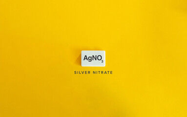 Silver Nitrate AgNO3 Chemical Compound on White Tile and Yellow Background