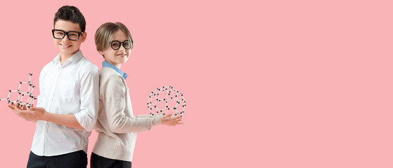 Happy brothers with molecular models on pink background