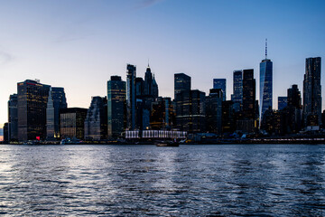 Manhattan downtown financial district across east river at sunset