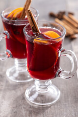 Mulled Wine with Orange and Cinnamon Sticks on wooden table
