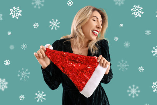 Happy woman with Santa hat on color background