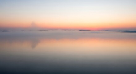 Fototapeta premium Serene Sunset Reflection on Calm Ocean Waters at Dusk.