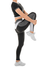 Sporty young woman in leggings on white background