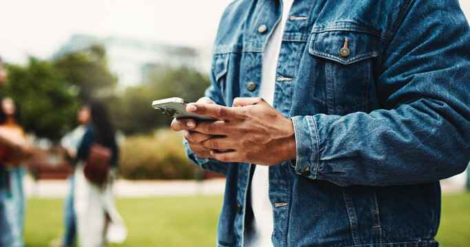 Man, student and hands with phone on campus for online chatting, social media or texting in park. Closeup, male person or user typing with mobile smartphone for app, scholarship or news in college