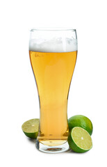 Glass of cold beer with lime on white background