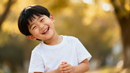 Portrait of a joyful asian 5-year-old boy in a T-shirt on a white background
