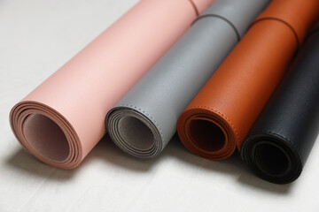 Fototapeta premium Different rolled computer mats on light grey table, closeup