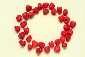 Frame made of fresh raspberries on light background