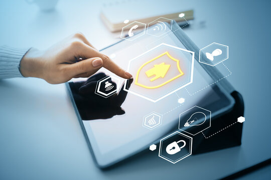 Cybersecurity interface with holographic padlock icons on tablet screen and hand interacting with digital protection system concept interface.