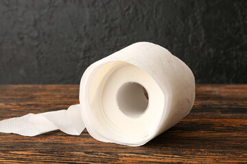 Roll of toilet paper on wooden table