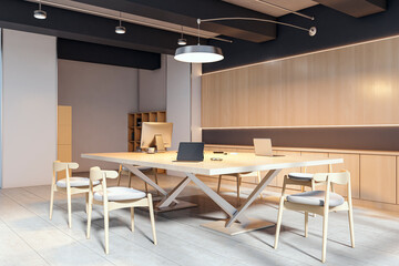 Modern light wood conference room interior with computers and elegant chairs in a stylish office environment with soft ambient lighting. 3D Rendering