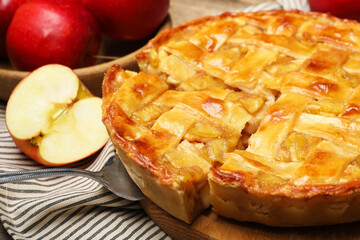 Delicious homemade pie and apples on table, closeup