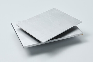 Metal surface sheets with brushed and matte finishes, showcasing industrial texture and modern material design for architecture, manufacturing, and product design applications.