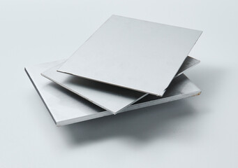 Metal surface sheets with brushed and matte finishes, showcasing industrial texture and modern material design for architecture, manufacturing, and product design applications.