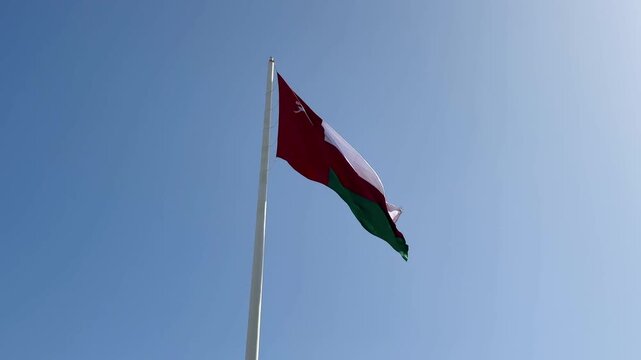 Oman Flag Blowing in Wind 4K Blue Sky Middle East Gulf Sultanate National Symbol Patriotism Footage