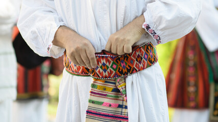 Vlach Man Adjusting Traditional Folk Belt