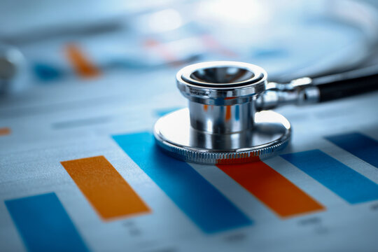 Stethoscope placed on colorful financial charts symbolizing healthcare data analysis and medical industry business trends and performance evaluation