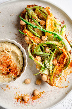 Bruschetta with hummus, asparagi and zucchini flower