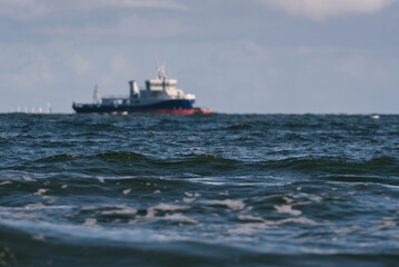 SEASCAPE - Ship at sea and foaming sea waves
