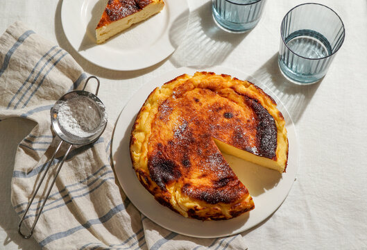 Basque Cheesecake in Natural Sunlight on Linen Tablecloth