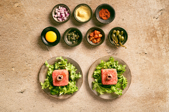 fresh raw tartare in plates with condiments