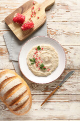 Plate of tasty baba ghanoush on white wooden background