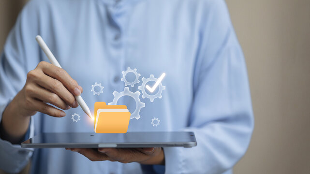 Hand Using Stylus on Tablet for Cloud Data Management and Automation System