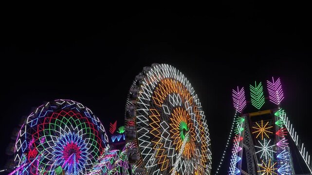 brightly lit Ferris wheel spinning in a colorful Indian fair at night. The glowing lights, people, and festive sounds capture the vibrant spirit of rural celebrations in India.