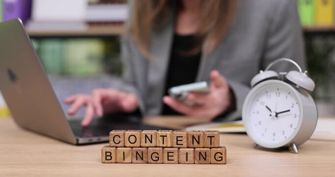 Engaging in content bingeing with mobile and laptop in a bright workspace during a productive afternoon