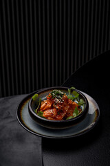 Cabbage kimchi on a plate in a restaurant on a dark background