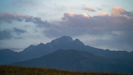 rocky mountain peaks in the clouds. evening in the mountains