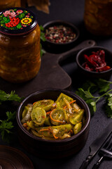 Pickled green tomatoes appetizer with herbs and spices