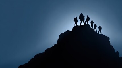 Silhouette of the team on the mountain. Leadership Concept.
