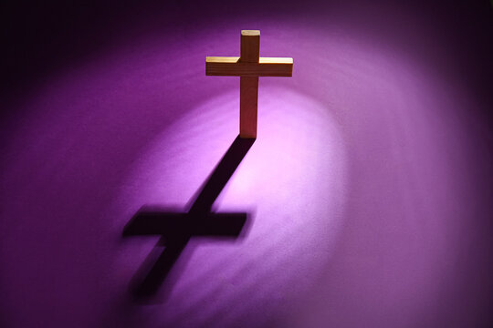 Wooden cross on purple background. Good Friday concept - Powered by Adobe