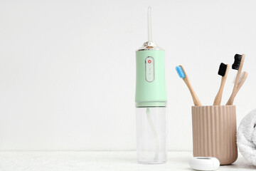 Simple set for oral hygiene with oral irrigator on white background