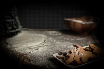 A plate of homemade gingerbread cookies displayed on a cozy Christmas and New Year background. Warm decorative lights, holiday atmosphere, and seasonal celebration concept. Perfect for festive, bakery